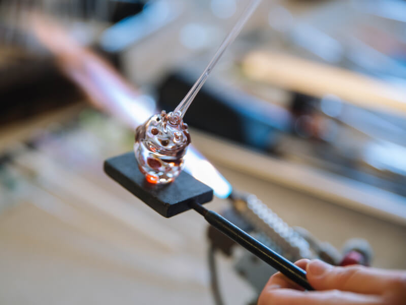 A close up of a piece of glass art made in a glass blowing class.